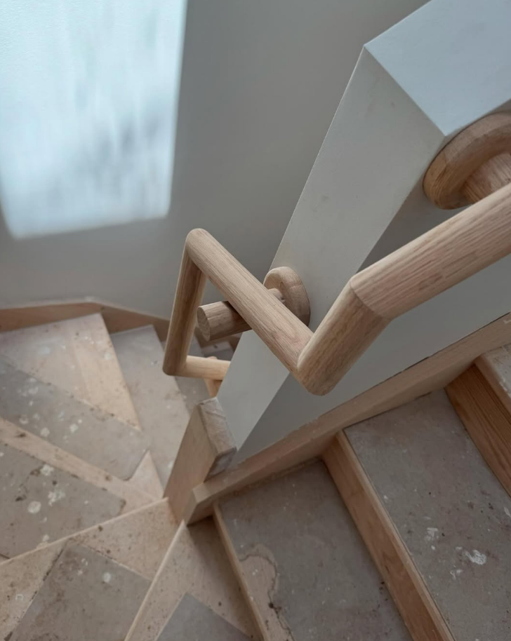 Detailed handrail joinery with curved timber joints